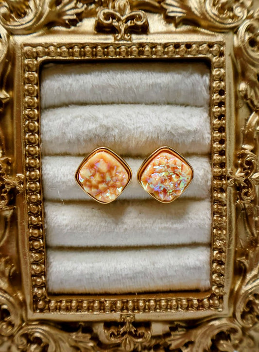 A pair of Coral Studs showcase a dazzling druzy texture that shimmers with natural brilliance.