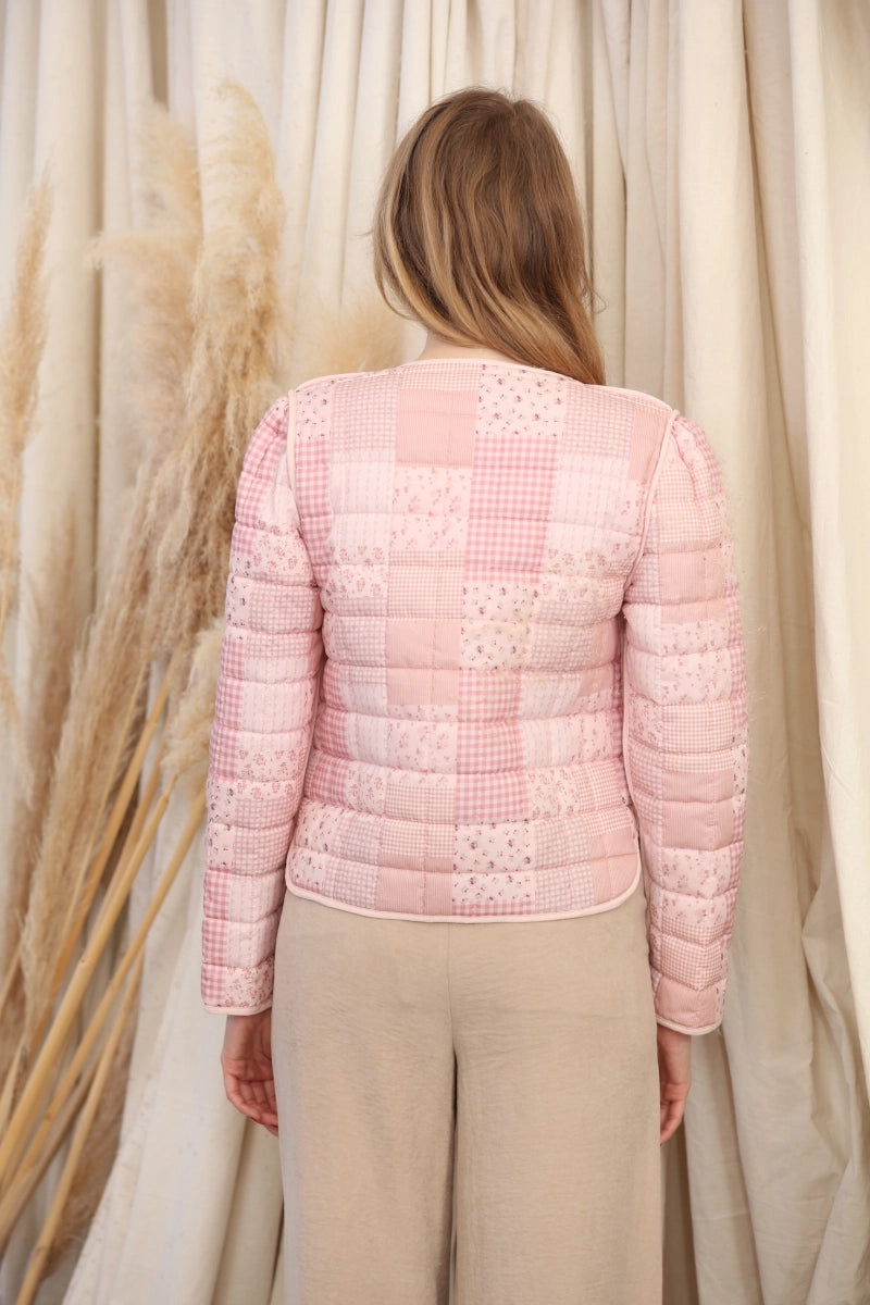 Reversible Quilted Jacket is a versatile and stylish layering piece that combines comfort with timeless charm. Crafted from voile fabric, this jacket features a quilted, patchwork print design and a flattering V-neckline.