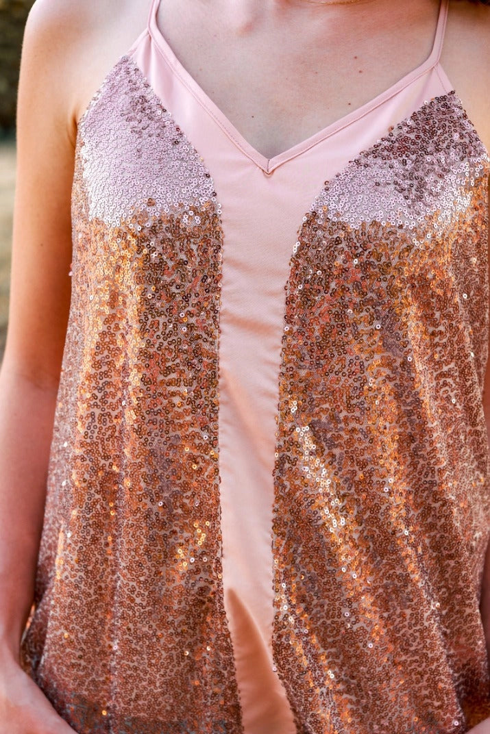 Rose Sequin Cami Top is a glamorous and eye-catching piece, perfect for special occasions or adding sparkle to your everyday look. Designed with a relaxed fit, this top features shimmering sequins throughout.