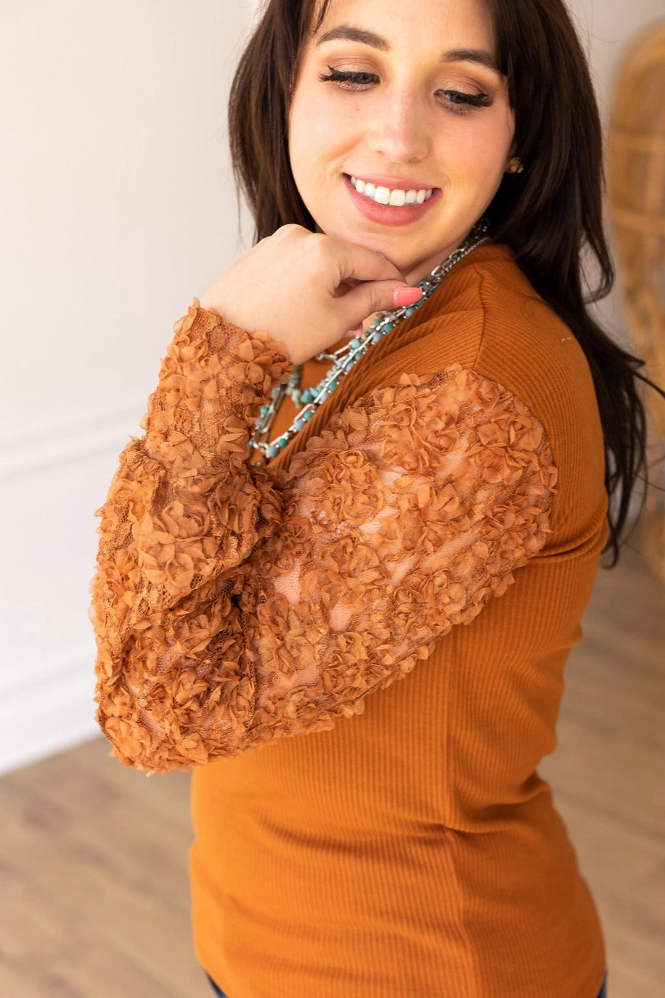 Rust Lace Sleeve Top combines timeless elegance with modern charm. Featuring intricate lace sleeves and a classic crew neckline.