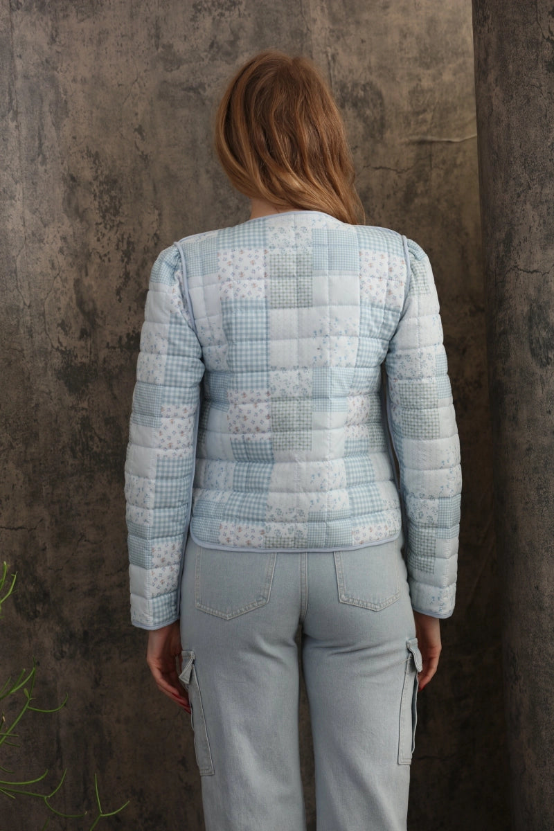Reversible Quilted Jacket is a versatile and stylish layering piece that combines comfort with timeless charm. Crafted from voile fabric, this jacket features a quilted, patchwork print design and a flattering V-neckline.