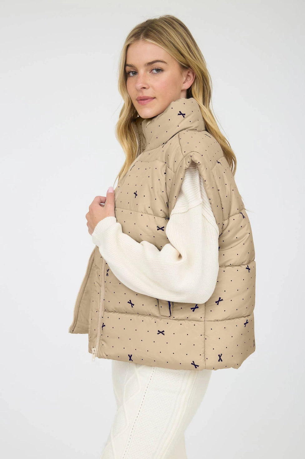 Light Khaki Polka Dot Bow Puffer Vest is a stylish and functional layering piece perfect for cooler weather.