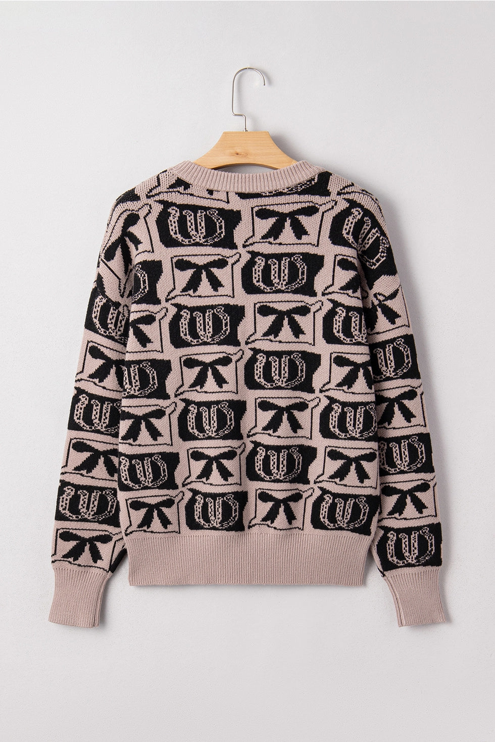 Western Print Sweater makes a bold statement with its unique bows and horseshoes pattern.