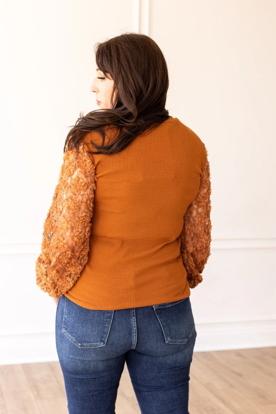 Rust Lace Sleeve Top combines timeless elegance with modern charm. Featuring intricate lace sleeves and a classic crew neckline.