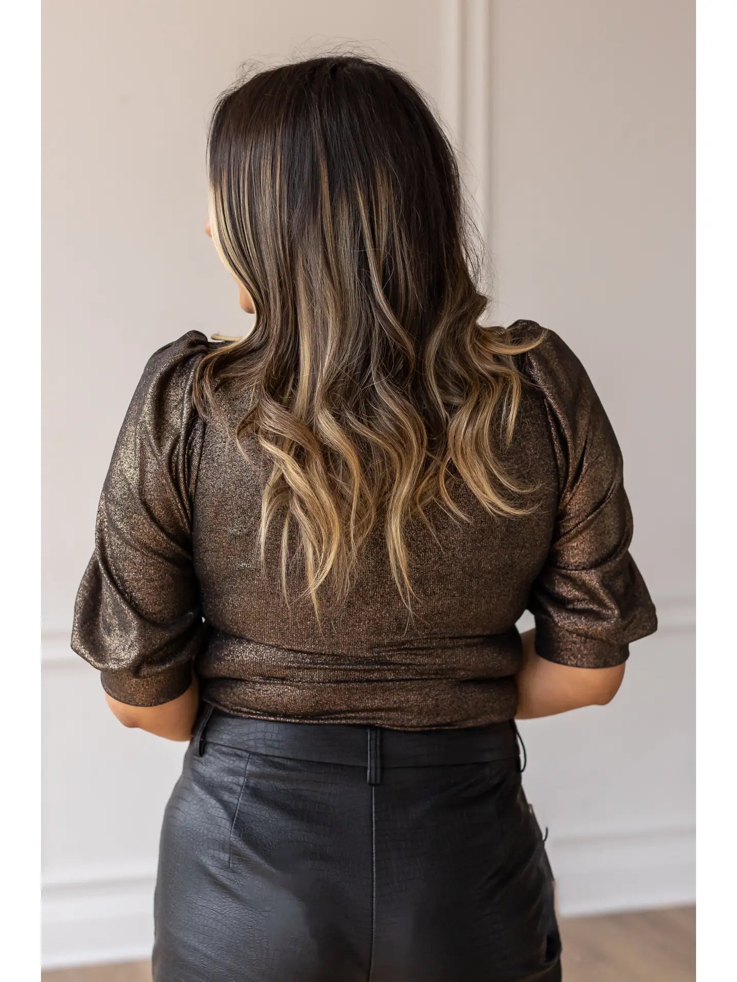 Metallic Puff Sleeve Bodysuit is a statement piece that brings elegance and glamour to any outfit. Featuring a shimmering metallic finish, puff sleeves, and a chic keyhole neckline.