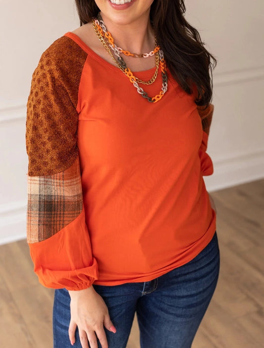 Rust/Orange Plaid Sleeve Crew Neck Top is a cozy and stylish piece that combines classic charm with modern details. Featuring a relaxed fit, semi-stretch fabric, and a comfortable crew neck.
