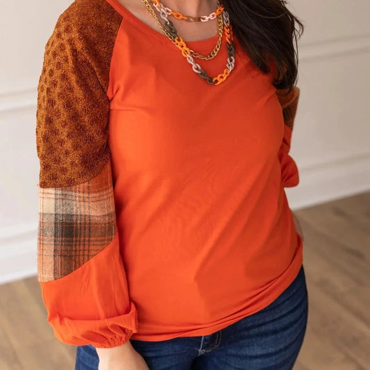 Rust/Orange Plaid Sleeve Crew Neck Top is a cozy and stylish piece that combines classic charm with modern details. Featuring a relaxed fit, semi-stretch fabric, and a comfortable crew neck.