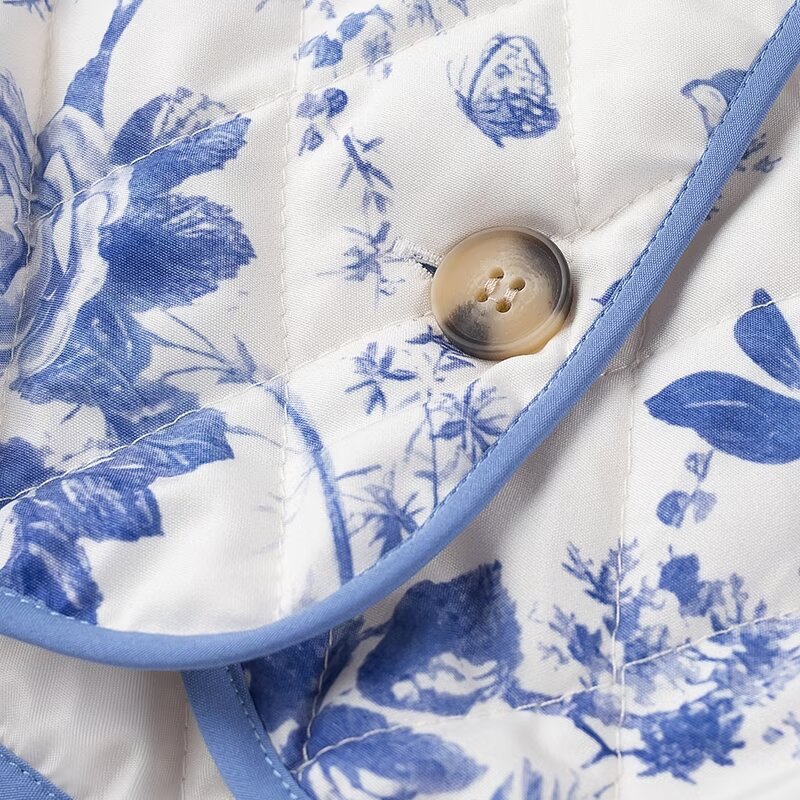 Blue Floral Quilted Jacket is a timeless and elegant piece that offers both style and comfort. Featuring a classic blue-and-white floral pattern, this lightweight quilted jacket is perfect for layering during cooler seasons.
