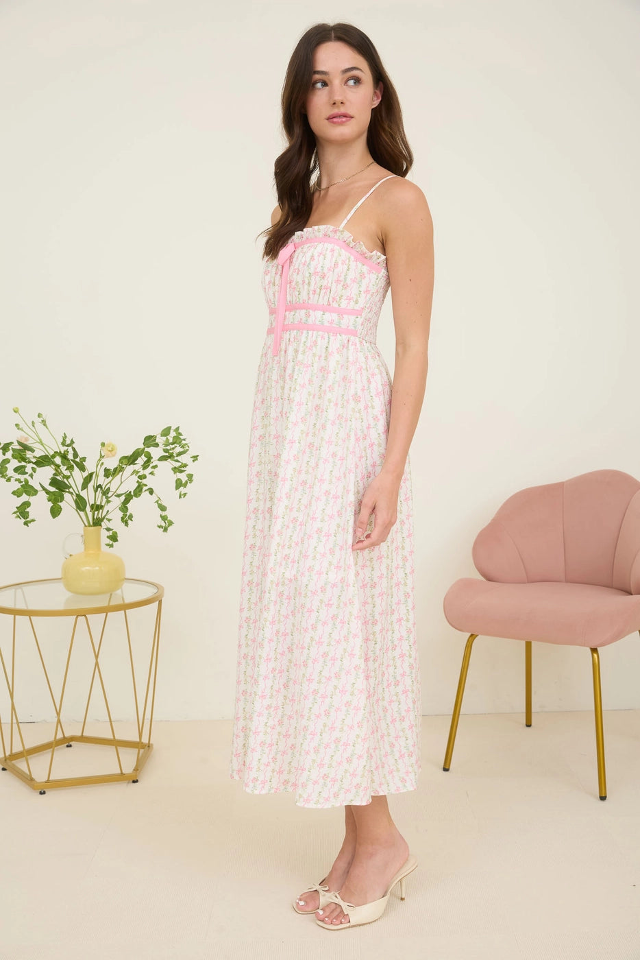 Pink Floral Bow Midi Dress. Featuring a square neckline with ruffle trim and adjustable spaghetti straps.