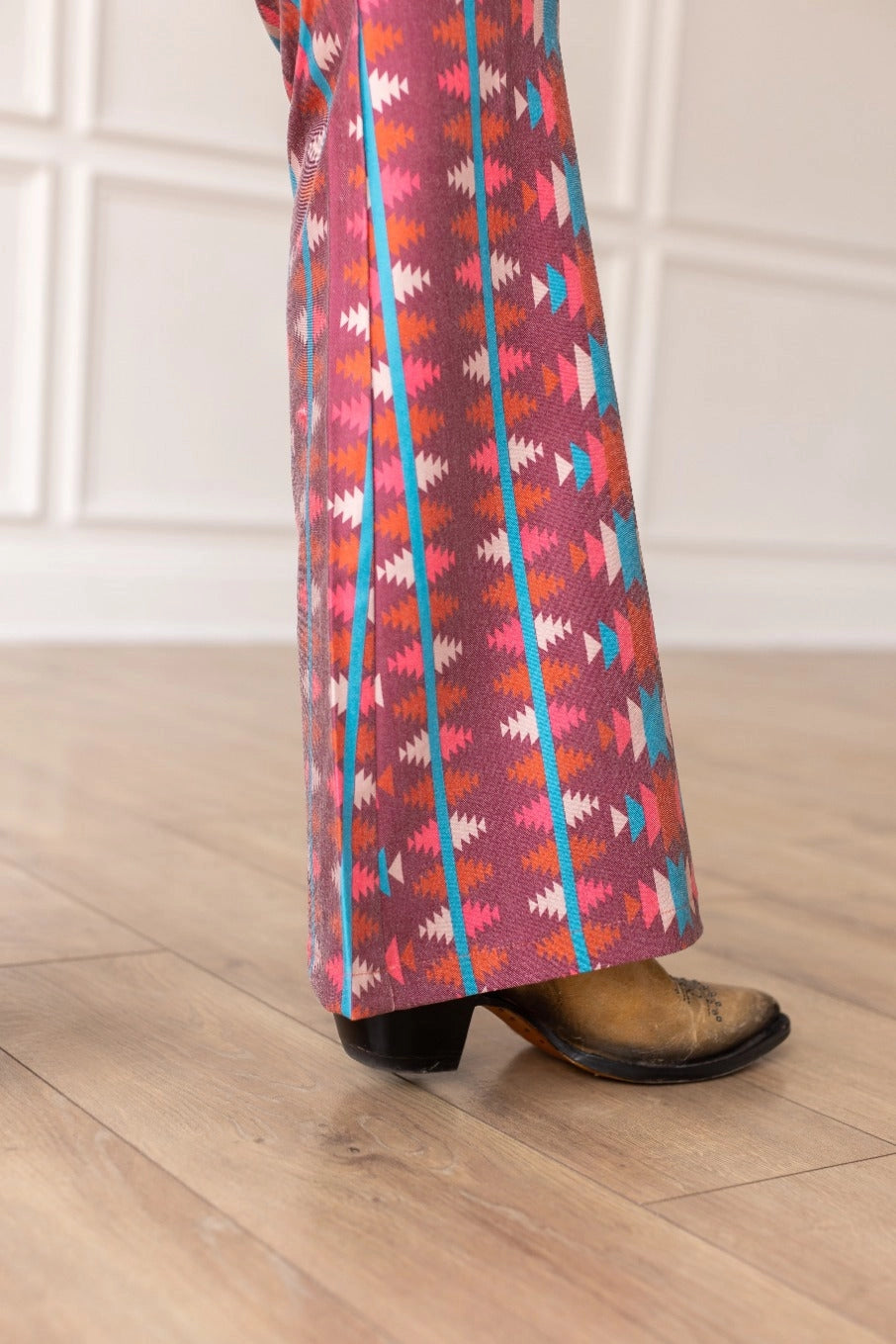 Aztec Flare Pants are a bold and stylish choice, designed to make a statement. These fitted pants feature a vibrant Aztec-inspired pattern and a flattering flared silhouette.