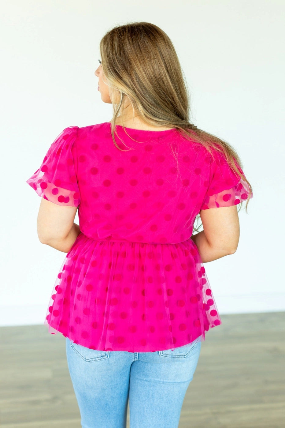 Polka Dot Peplum Blouse is a chic and versatile piece designed for effortless transitions from day to date night. Featuring a crew neck, flattering peplum silhouette, and an elastic waistband.