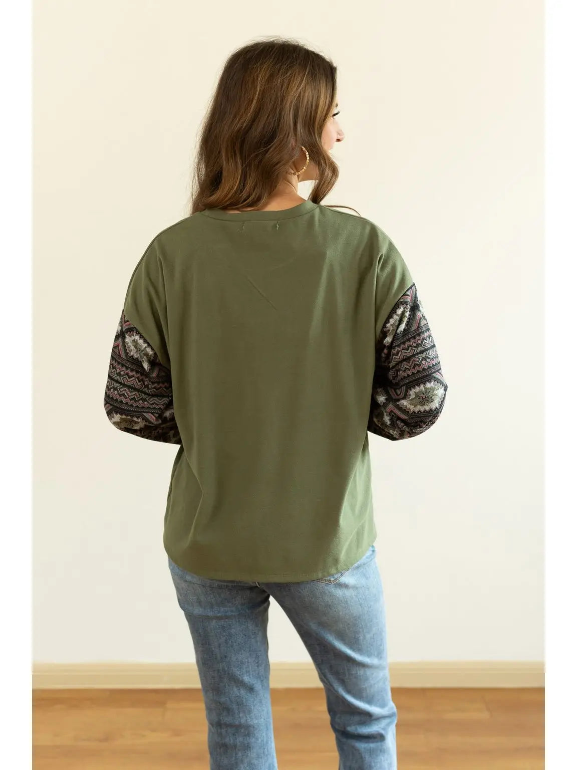 Aztec Sleeve Top is a stylish blend of simplicity and bold design. Featuring a solid olive-green.