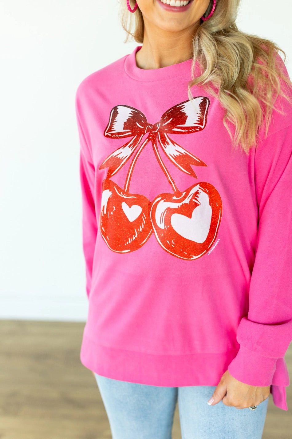 Cherry Graphic Sweatshirt is a fun and bold statement piece. Designed with an oversized fit, split hem.