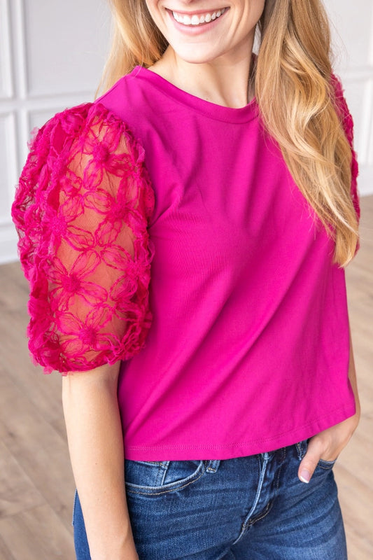 Magenta Lace Puff Sleeve Top is a perfect combination of elegance and simplicity. Featuring delicate sheer lace puff sleeves and a classic boat neckline.