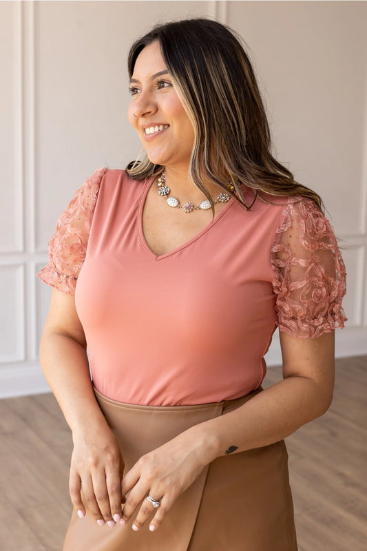  Lace Sleeve Bodysuit is a stunning piece that combines comfort and elegance. Featuring delicate lace puff sleeves and a flattering V-neckline.