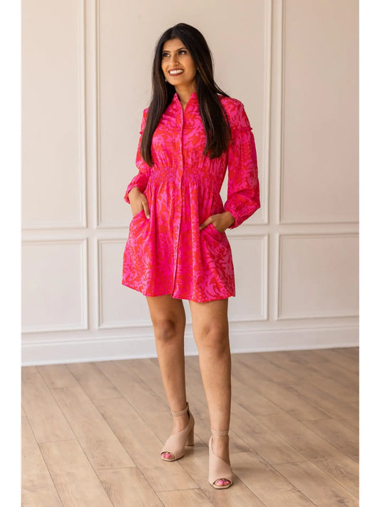  Smocked Button-Up Dress is a vibrant and elegant piece that combines comfort with effortless style. Featuring a bold floral pattern, a smocked waist for a flattering silhouette, and a button-up front for added versatility. 