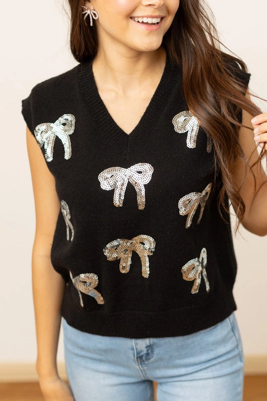 Sequin Bow Vest is a fun and stylish piece that adds a playful yet chic touch to your wardrobe. Adorned with shimmering sequin bows and featuring a classic V-neckline.