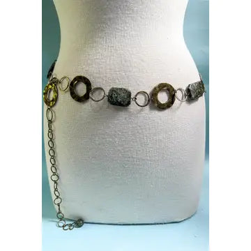 Belt with circular and chain design on a mannequin gainst a light blue background