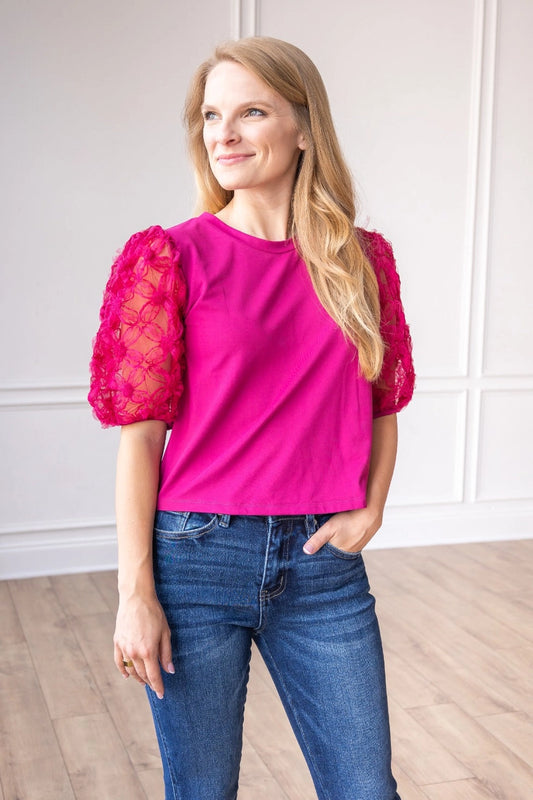  Magenta Lace Puff Sleeve Top is a perfect combination of elegance and simplicity. Featuring delicate sheer lace puff sleeves and a classic boat neckline.