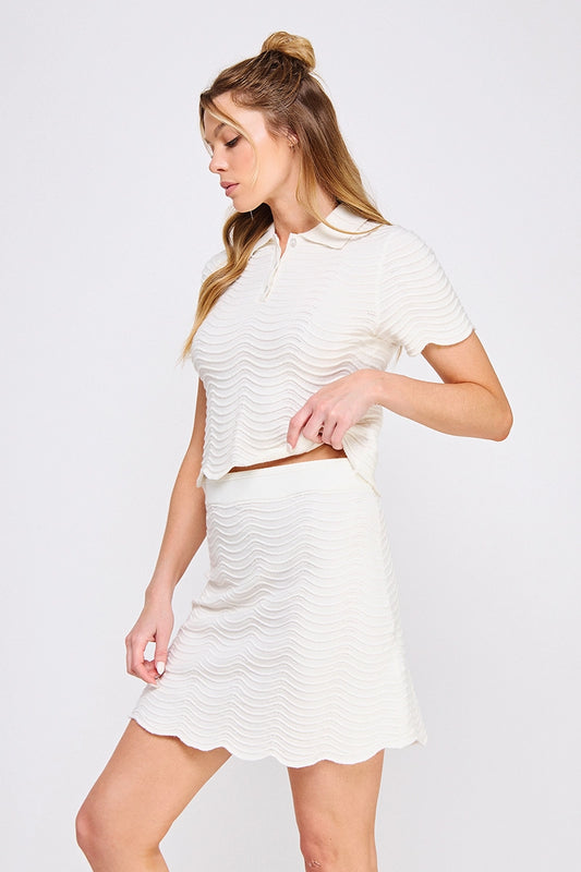Cream Scallop Knit Polo Top is a sophisticated blend of elegance and comfort. 