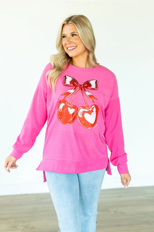  Cherry Graphic Sweatshirt is a fun and bold statement piece. Designed with an oversized fit, split hem.