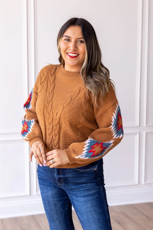  Cable Knit Aztec Sweater brings together cozy warmth and eye-catching design. Featuring a relaxed fit, this sweater is crafted with classic cable-knit detailing on the body and bold Aztec-inspired patterns on the sleeves. 