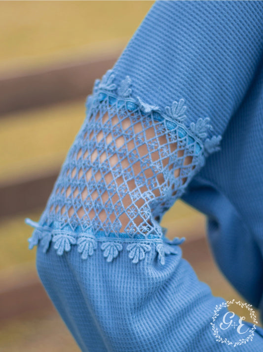 Denim Blue Lace Accent Top is a perfect blend of comfort and style. Featuring delicate lace details on the sleeves and a relaxed fit.