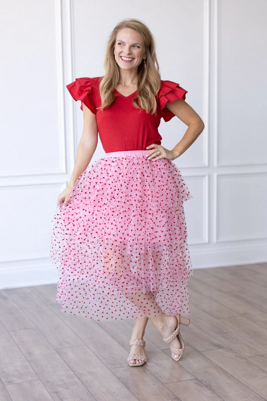 Heart Tiered Tulle Skirt is a whimsical and romantic piece perfect for adding a playful touch to your wardrobe. Featuring multiple layers of soft tulle adorned with delicate heart patterns.