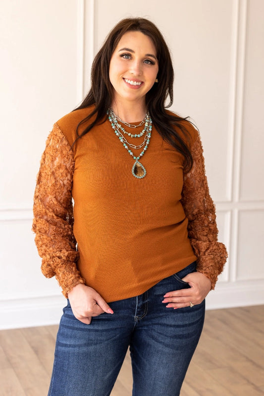 Rust Lace Sleeve Top combines timeless elegance with modern charm. Featuring intricate lace sleeves and a classic crew neckline.