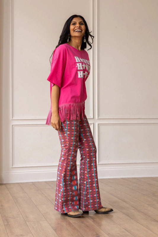 Aztec Flare Pants are a bold and stylish choice, designed to make a statement. These fitted pants feature a vibrant Aztec-inspired pattern and a flattering flared silhouette.