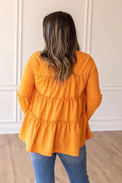 Orange Babydoll Top is a breezy and feminine piece designed for both comfort and style. With its relaxed fit and flowy tiered silhouette.