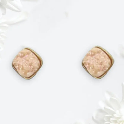 Pair of square-shaped earrings with a beige center and gold border on a white background.