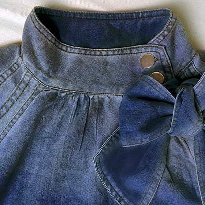  Puff Sleeve Denim Blouse is a stylish and versatile piece that combines casual comfort with a chic design. Featuring 3/4-length loose puff sleeves and a high neckline adorned with a statement bow.