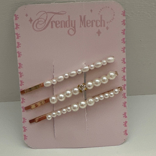 Three pearl-barrel hair pins with rose gold metal and a small rhinestone accent, displayed on a pink 'Trendy Merch' backing card against a neutral gray background.