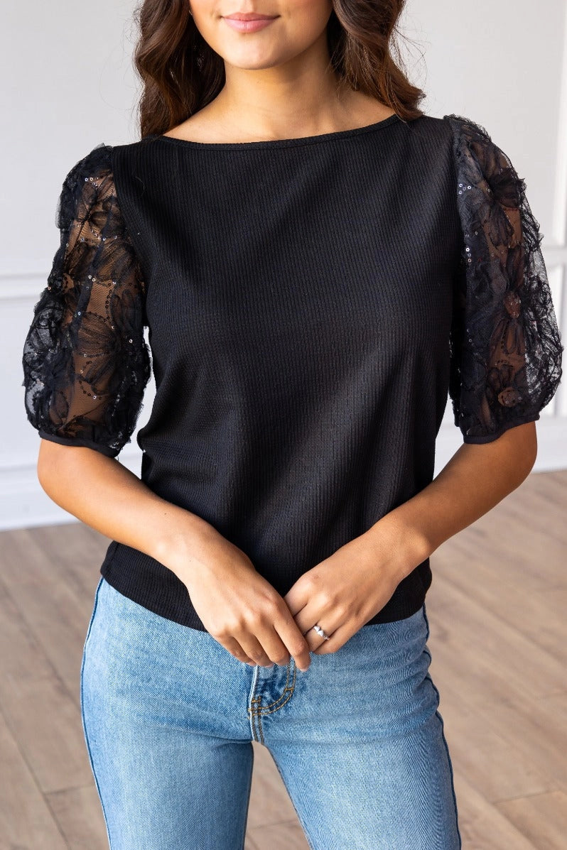  Lace Puff Sleeve Top is a perfect combination of elegance and simplicity. Featuring delicate sheer lace puff sleeves and a classic boat neckline.
