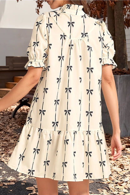 Bow Print Dress. The short puff sleeves and tiered hem create a flattering silhouette, while the high neckline with a button-front detail.