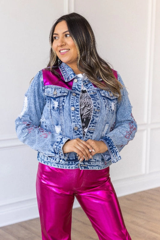  Denim Jacket is a striking blend of classic denim and glamorous details. Featuring a fitted silhouette, distressed touches, vibrant satin panels, and jeweled accents. 