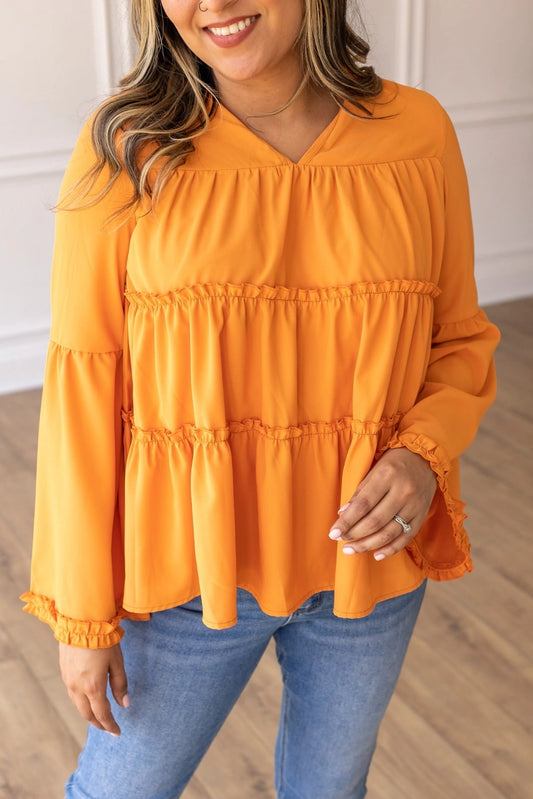 Orange Babydoll Top is a breezy and feminine piece designed for both comfort and style. With its relaxed fit and flowy tiered silhouette.