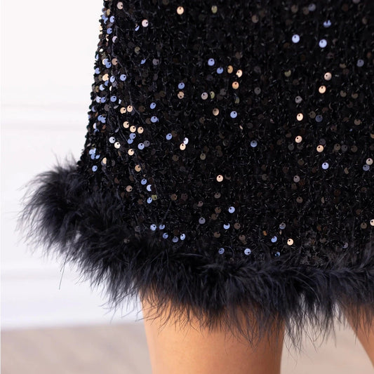 One-Shoulder Sequin Mini Dress. Featuring a fitted silhouette, dazzling black sequins, and a chic one-shoulder design.