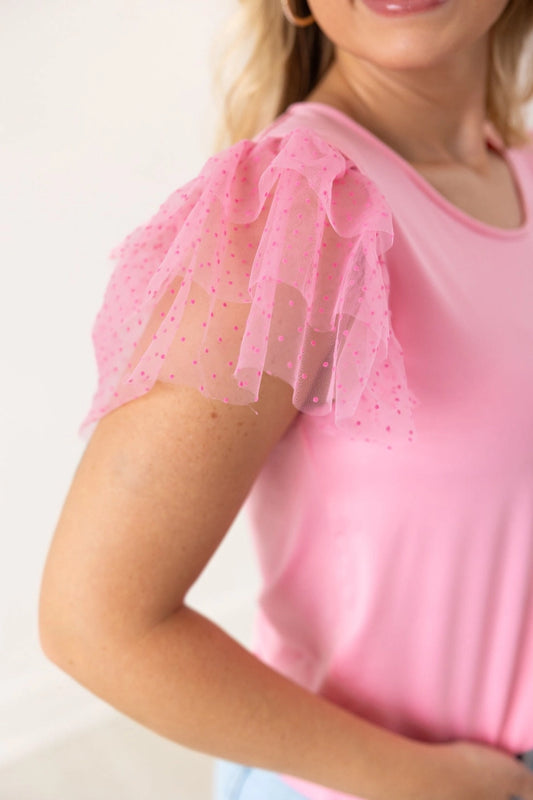 Pink Ruffle Sleeve Top is a fun and feminine piece that adds a playful touch to any outfit. Featuring delicate polka-dot mesh ruffle sleeves and a soft, lightweight fabric.