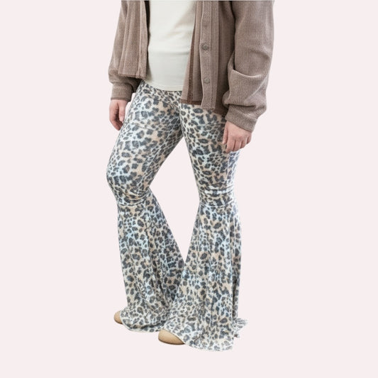 Person wearing leopard print flared pants against a plain background