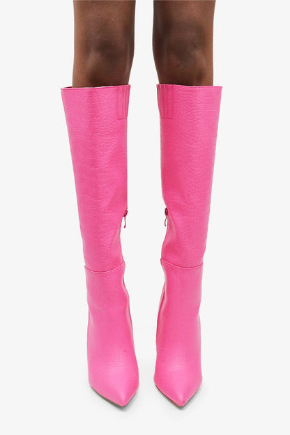  Croc Knee-High Boots are a bold statement piece designed to elevate any outfit. Featuring an eye-catching croc-embossed texture and a vibrant pink hue.