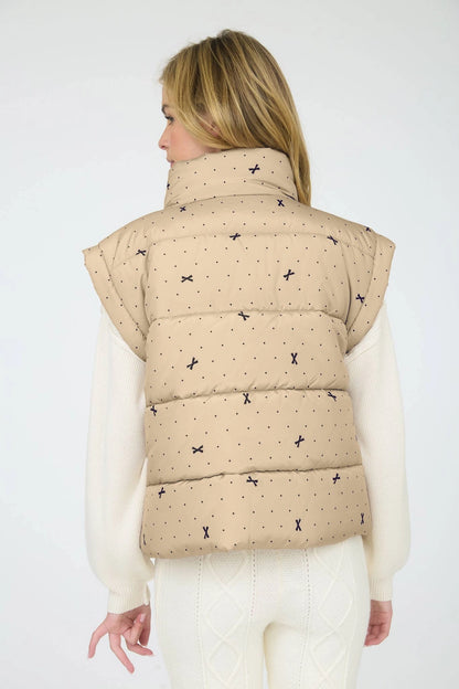 Light Khaki Polka Dot Bow Puffer Vest is a stylish and functional layering piece perfect for cooler weather. 
