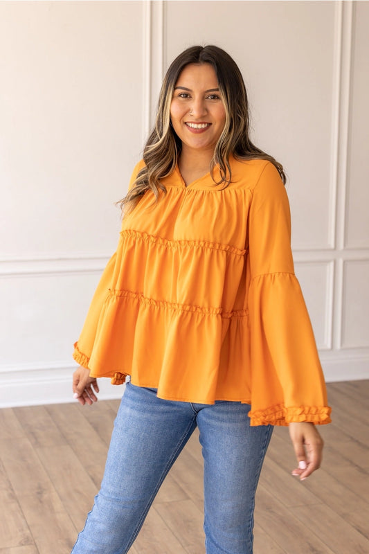Orange Babydoll Top is a breezy and feminine piece designed for both comfort and style. With its relaxed fit and flowy tiered silhouette.