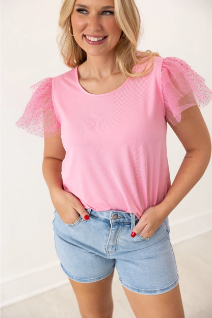 Pink Ruffle Sleeve Top is a fun and feminine piece that adds a playful touch to any outfit. Featuring delicate polka-dot mesh ruffle sleeves and a soft, lightweight fabric.