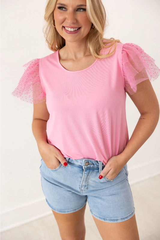 Pink Ruffle Sleeve Top is a fun and feminine piece that adds a playful touch to any outfit. Featuring delicate polka-dot mesh ruffle sleeves and a soft, lightweight fabric.