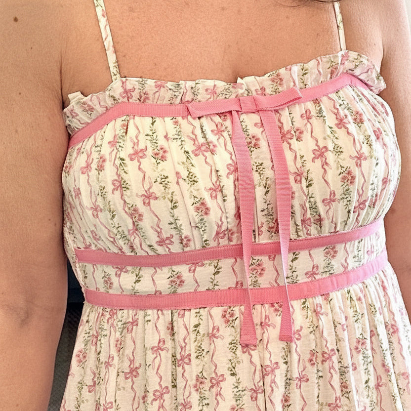 Woman wearing a floral dress with pink accents