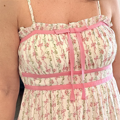 Woman wearing a floral dress with pink accents