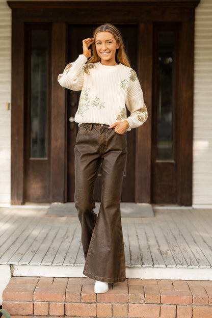  High-Rise Leather Flare Pants are a chic and edgy addition to your wardrobe. Designed with a fitted silhouette through the waist and hips, these pants feature a high-rise waistline, a zipper fly, and a dramatic flared leg. 