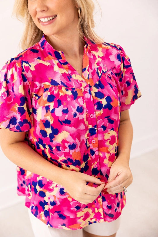  Floral Blouse is a vibrant and stylish addition to your wardrobe. Designed with a button-front closure and chic puff sleeves.